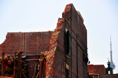 Building in the Distillery District being demolished; ever-present CN Tower in the background