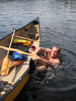 Matt trying to get in his canoe from the water