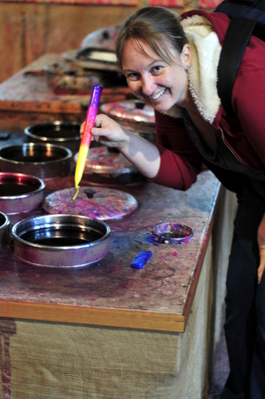 Toni dipping a candle (in 'authentically' coloured wax)