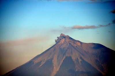 A distant volcano belching ash