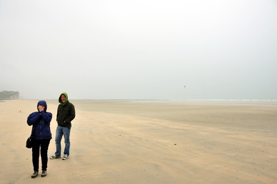 We found a sandy beach although it was still raining and windy. You can see kite-surfers in the background.