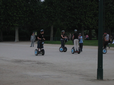 Some crazy people zipping around on Segways for some reason