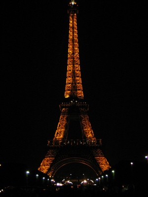 The Eiffel Tower all lit up taken from the Champ de Mars