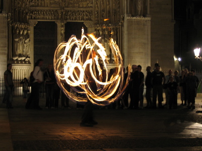A long exposure of the cool fire street performer in front of Notre Dame