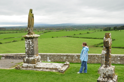 Kim examining a grave stone in the cemetery at the Rock of Cashel