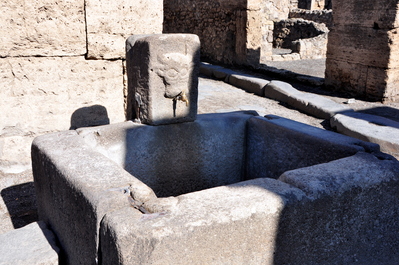 A public water fountain, you can see on the sides where it is worn down from use