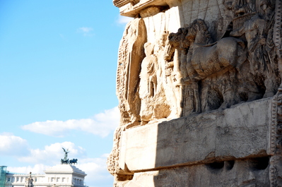 Detail on Arch of Titus with National Monument in background