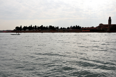 Lonely gondolier between Murano and the cemetery island