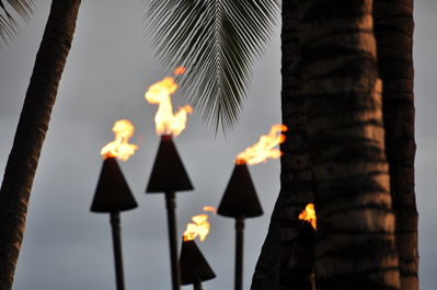 Torches all over the resort are lit at sunset by a running man