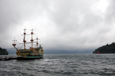 Parked pirate ship and torii gates on Lake Ashi