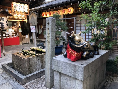 Random shrine in the middle of a busy shopping district