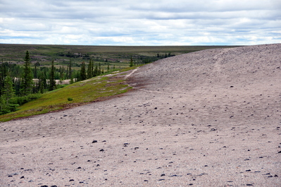 On top of the esker. The trails are old caribou migration paths. They walked on the eskers to be in the wind in order to get relief from the bugs.