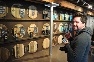 Mike and the wall of whiskys at Bruichladdich