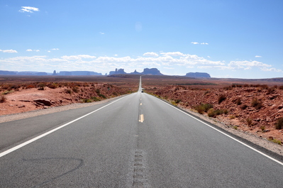 Looking back (along a straight road) to Monument Valley